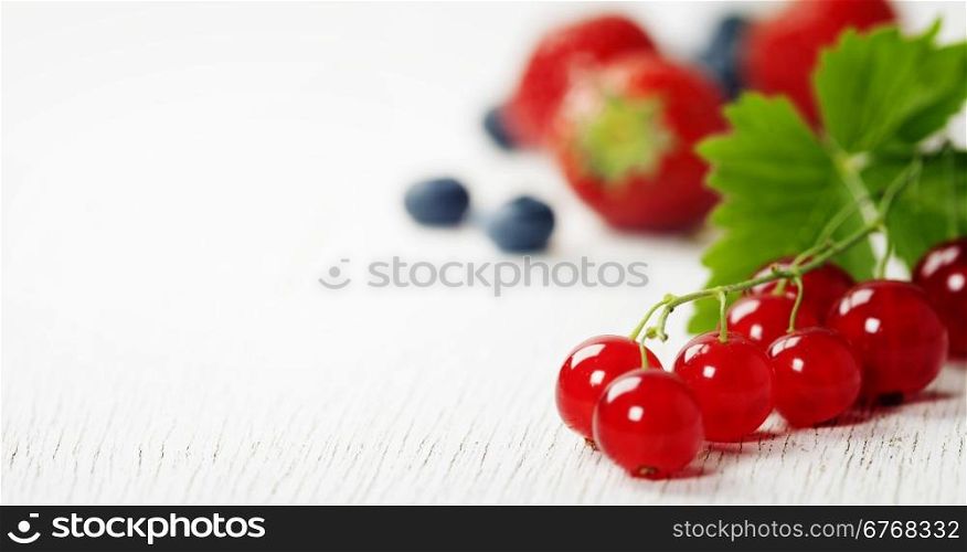 Mix of fresh berries on rustic wooden background