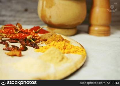 Mix of indian spices in a wooden table                               