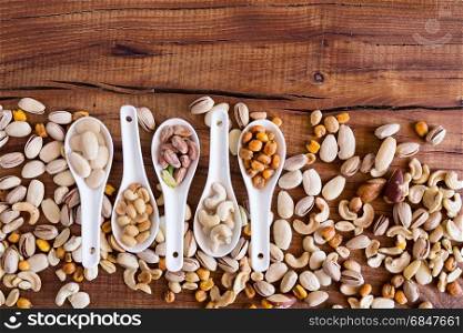 Mix of nuts over a rustic table seen from above. Mix of nuts over a rustic table