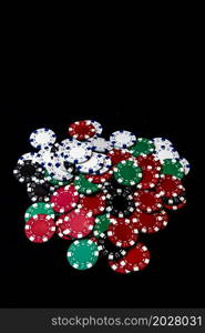 Mix of poker chips on black background