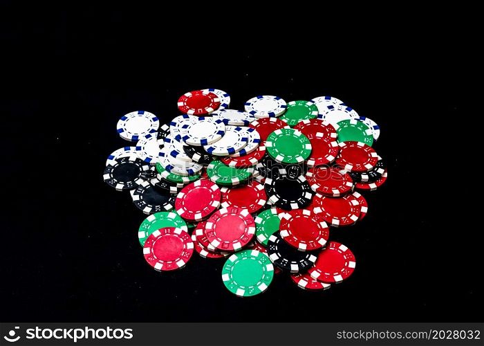 Mix of poker chips on black background