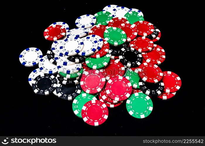 Mix of poker chips on black background