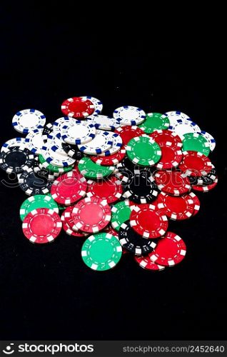 Mix of poker chips on black background