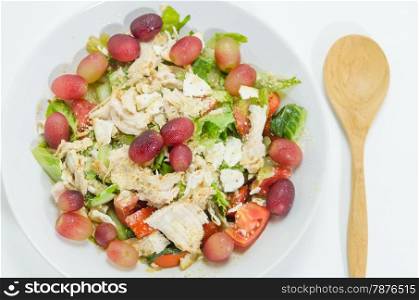 Mix salad. Mix salad with grapes and chicken on white dish