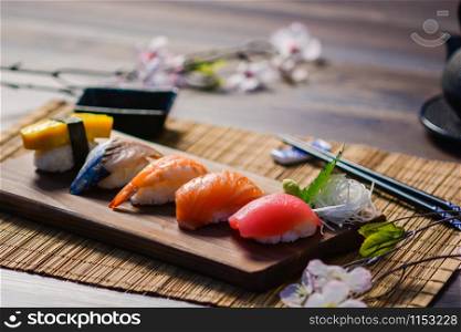 Mix sushi on wood dish, tuna, salmon, sea bass, sweet egg, shrimp sushi, Japanese food