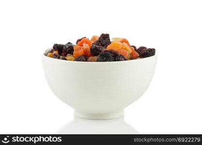 Mix variety of dried fruit in bowl over white background