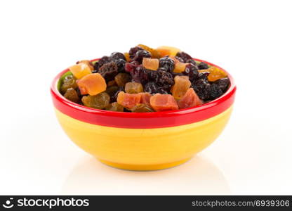 Mix variety of dried fruit in bowl over white background
