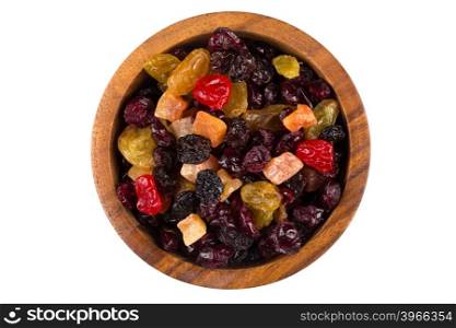 Mix variety of dried fruit in wooden bowl over white background