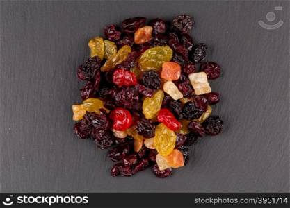 Mix variety of dried fruiton black dark stone background