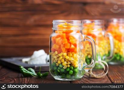 mix vegetables in glass bank and on a table