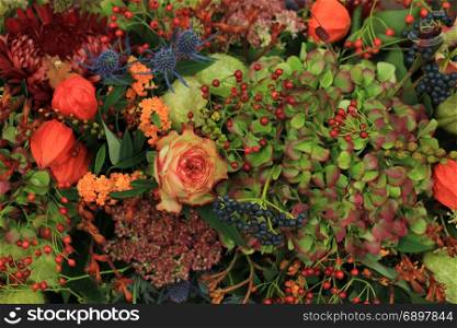 Mixed autumn flower arrangement: various flowers in different autumn colors for a fall wedding