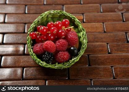 Mixed berries in a green little basket