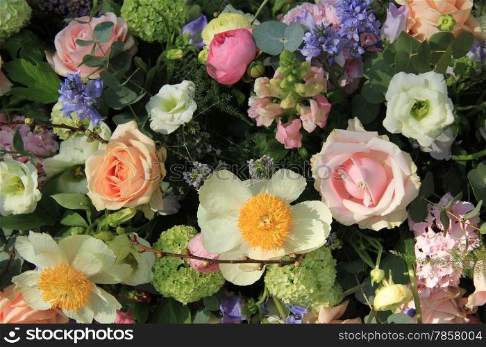 Mixed bridal flower decorations: peonies, ranunculus and roses in pastel colors