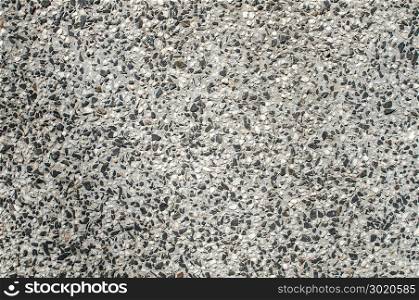 Mixed cement and small stone gravel mosaic slab surface closeup as background