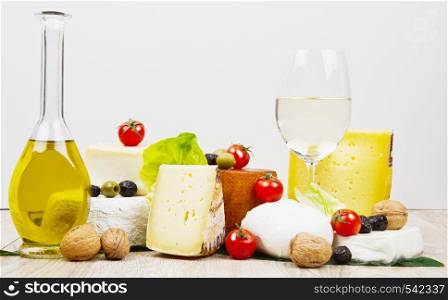 mixed cheese with oil,olive and nut on wood table