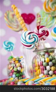 Mixed colorful sweets, lollipops and candy. Colorful lollipops and different colored round candy and gum balls