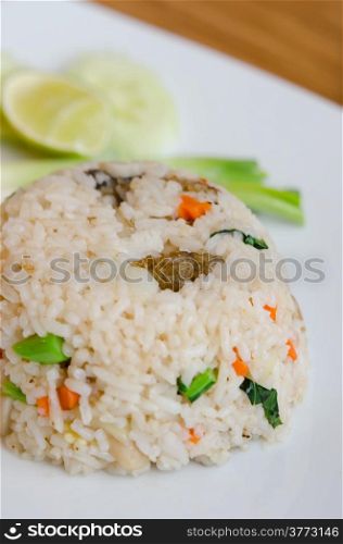 Mixed cooked rice with fried fish , sauce and vegetable