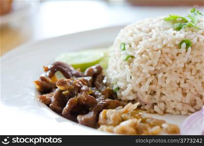 Mixed cooked rice with pork sauce and fresh vegetable , Thai favorite food of rice