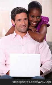 Mixed couple with laptop