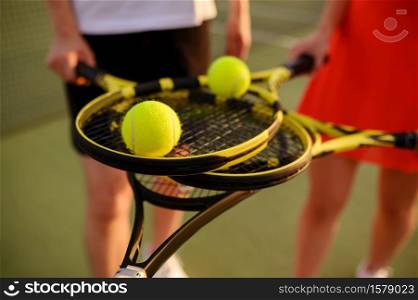 Mixed doubles tennis, players with rackets and balls, top view, outdoor court. Active healthy lifestyle, sport game training, fitness workout with racquets. Mixed tennis, players with rackets and balls