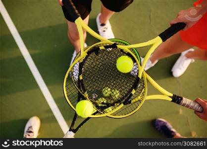 Mixed doubles tennis, players with rackets and balls, top view, outdoor court. Active healthy lifestyle, sport game training, fitness workout with racquets. Mixed tennis, players with rackets and balls