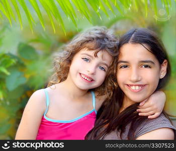 Mixed ethnicity cousin friends hug latin and caucasian in jungle garden