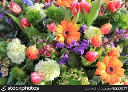 Mixed floral arrangement in bright colors with carnations, tulips and gerberas