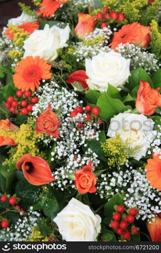 Mixed floral arrangement in orange and white