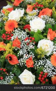 Mixed floral arrangement in orange and white