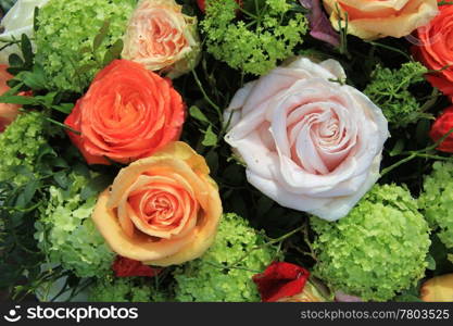 Mixed floral arrangement in orange, yellow, pink and green
