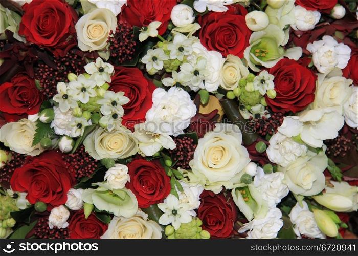 Mixed floral arrangement with red and white roses and lilies