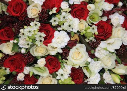 Mixed floral arrangement with red and white roses and lilies