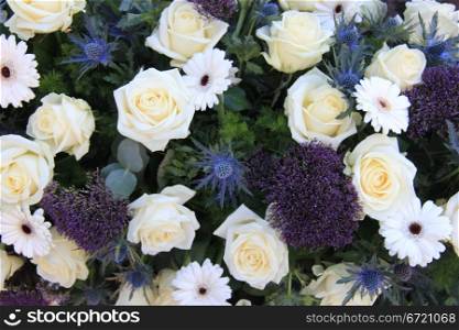 Mixed floral arrangement with white roses and blue flowers