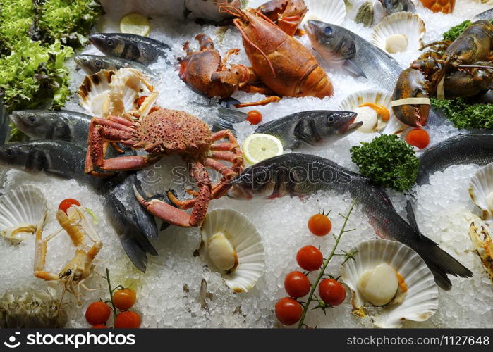 Mixed fresh seafood on ice for the open market in close up top view format