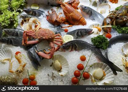 Mixed fresh seafood on ice for the open market in close up top view format