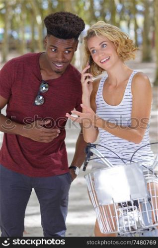 mixed friends have rest after riding bicycles