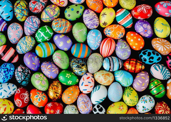 Mixed many colorful easter eggs on ground. Abstract background. Holidays backdrop.