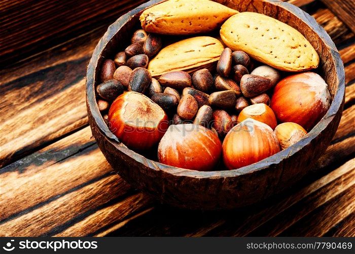 Mixed nuts in a bowl on wooden table.Healthy food. Assorted mixed nuts