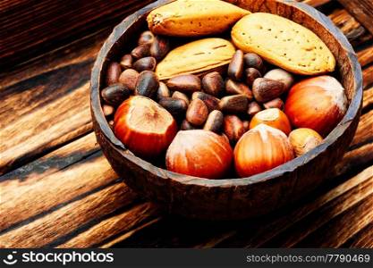 Mixed nuts in a bowl on wooden table.Healthy food. Assorted mixed nuts