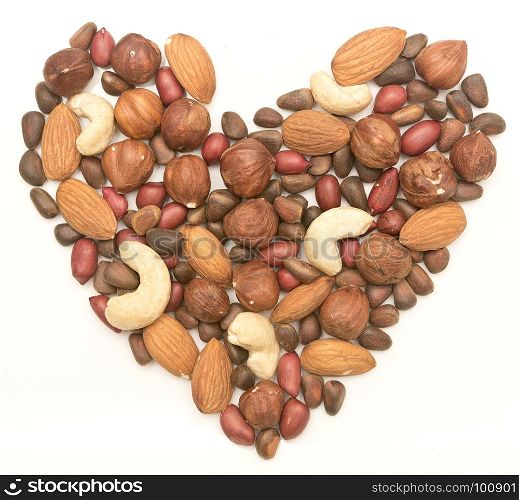 mixed nuts in the shape of the heart on white background