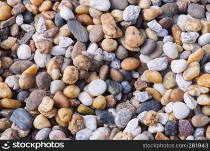 Mixed of multi-color of pebble stones in different size background. Closeup, Top view.