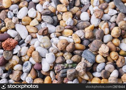 Mixed of multi-color of pebble stones in different size background. Closeup, Top view.