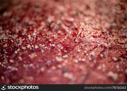Mixed pepper and spices on the raw meat steak close up