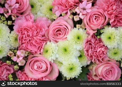 Mixed pink flowers in a floral wedding decoration. Pink wedding flowers