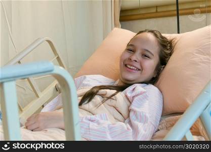 Mixed race Asian American tween girl in hospital bed