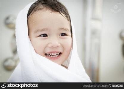 Mixed Race Boy Having Fun at the Water Park with White Towel On His Head.