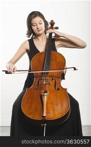 Mixed race cellist sits playing