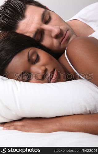 Mixed-race couple asleep