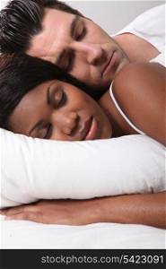 Mixed-race couple asleep
