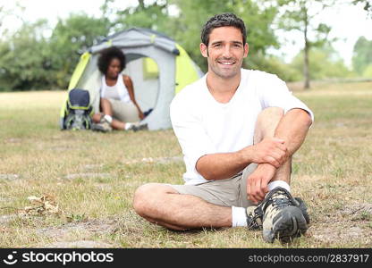 Mixed race couple camping in tent